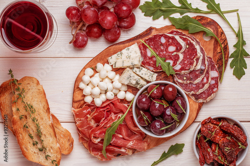 Wine snack set. Variety of cheese and meat, olives, grapes, arug