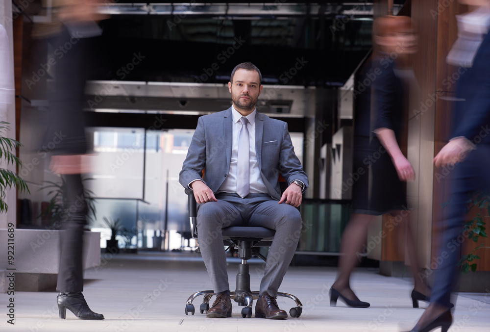 business man sitting in office chair, people group passing by business man sitting in office chair, people group passing by