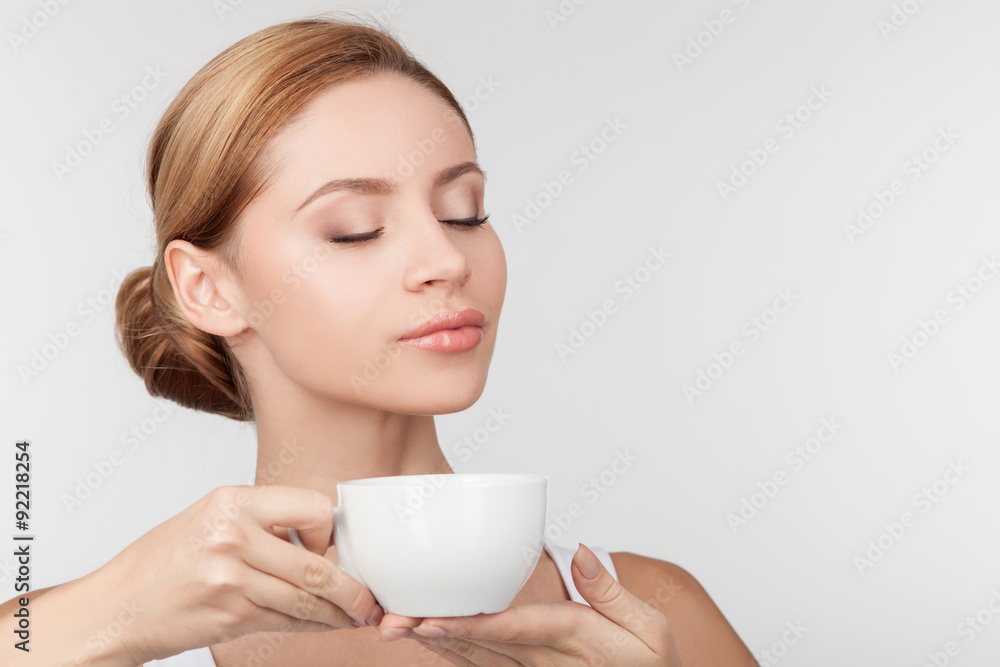 Cheerful healthy girl drinks tea with pleasure Cheerful healthy girl drinks tea with pleasure
