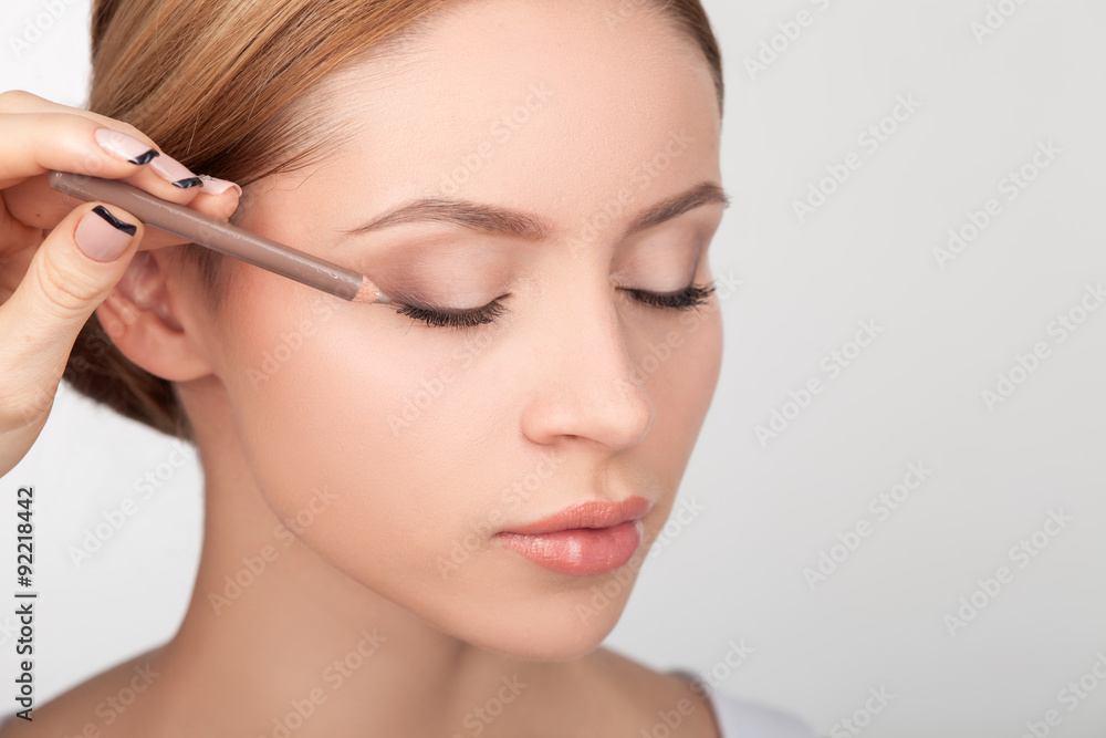 Professional makeup artist is painting female eyes Professional makeup artist is painting female eyes