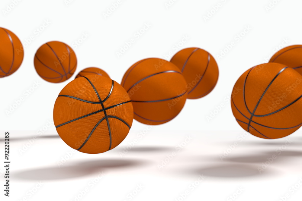 Levitation of the basketballs in front of the white background. Focus to the nearest ball.