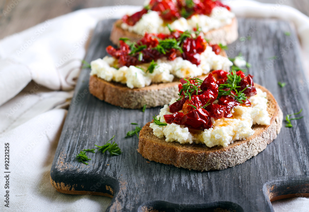 Bread slices with ricotta cheese and, sun dried tomatoes Bread slices with ricotta cheese and, sun dried tomatoes