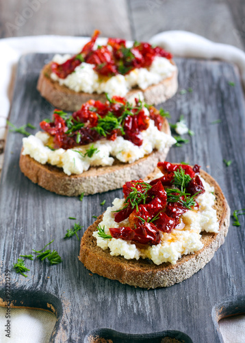 Bread slices with ricotta cheese and, sun dried tomatoes