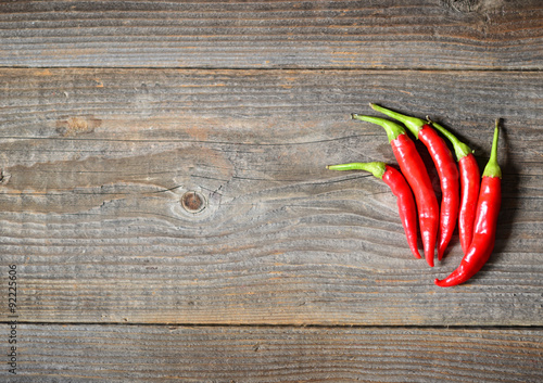 Chilly pepper on the wooden background