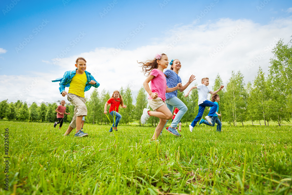 Children are running through green field together Children are running through green field together