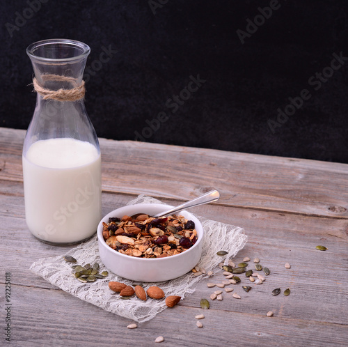 Granola Cereal with bottle of milk on wooden table