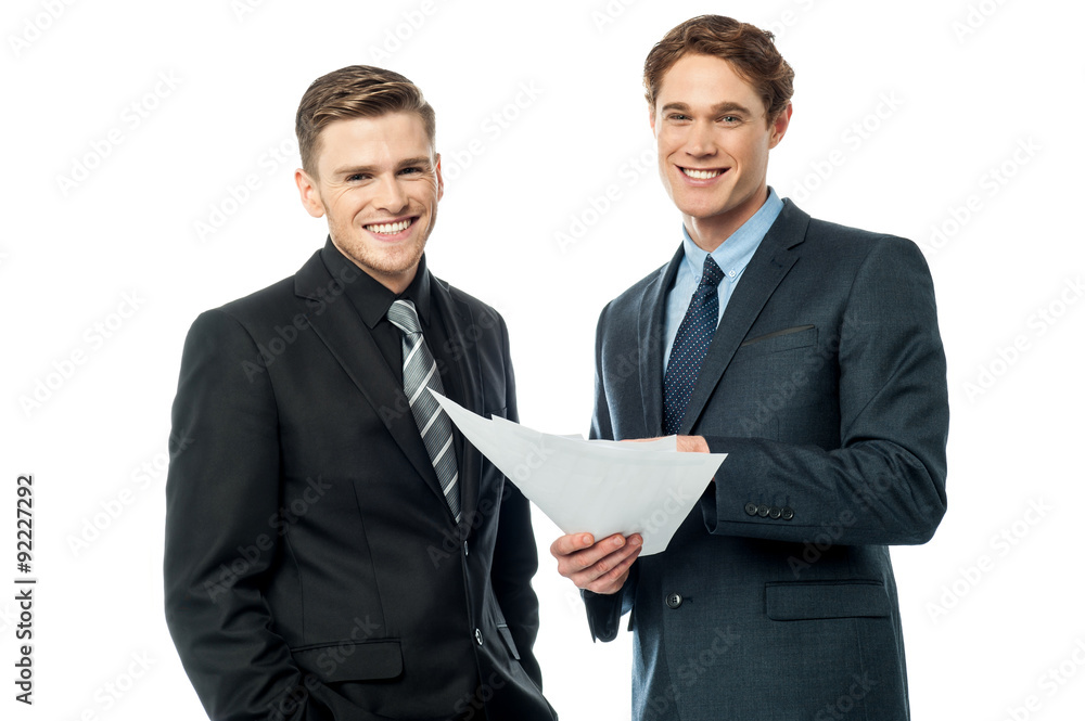 Business partners discussing reports Business partners discussing reports