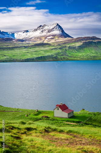 Small cottage in the mountains above the fjord in Iceland