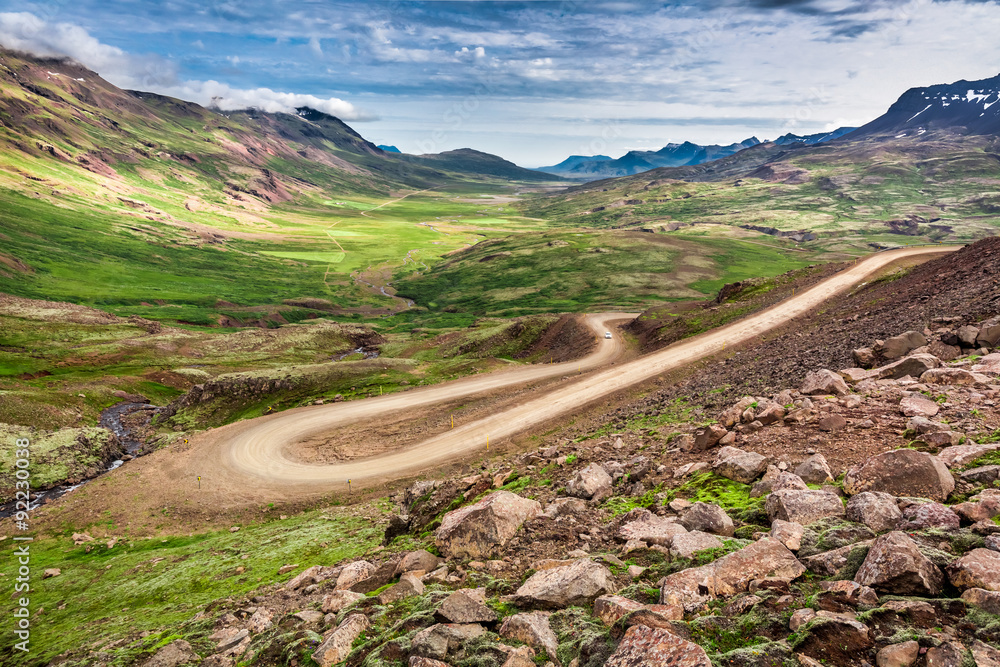 Winding mountain road leading to the valley in Iceland