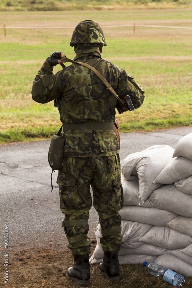 Fototapeta premium soldier in a camouflage suit fights