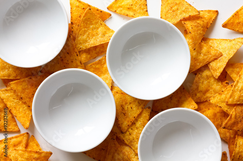 Four white round empty ceramic bowls from above with tortilla ch photo