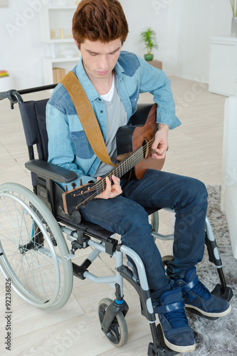 Handicapped teenager playing the guitar