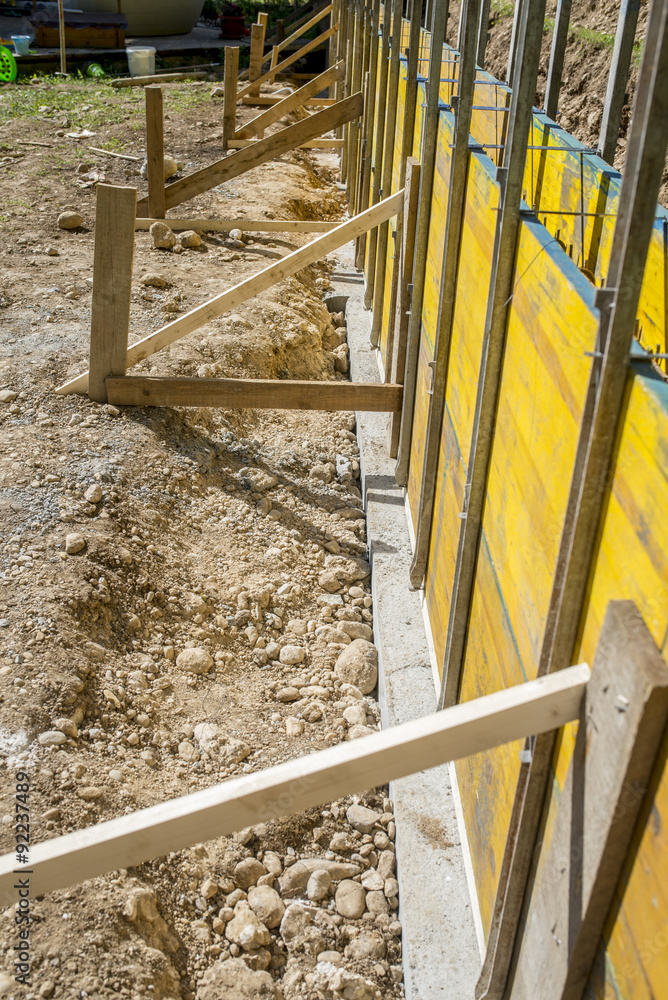 Construction site with supported wooden yellow panels Construction site with supported wooden yellow panels