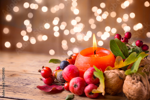 Autumn decoration with burning candle photo