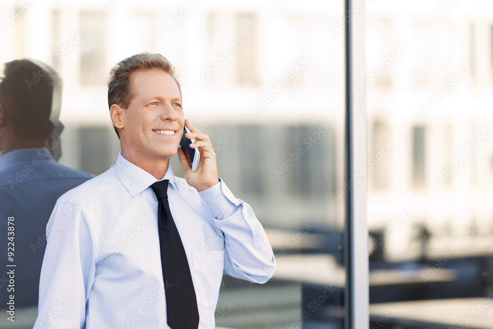 Nice businessman standing near office building Nice businessman standing near office building