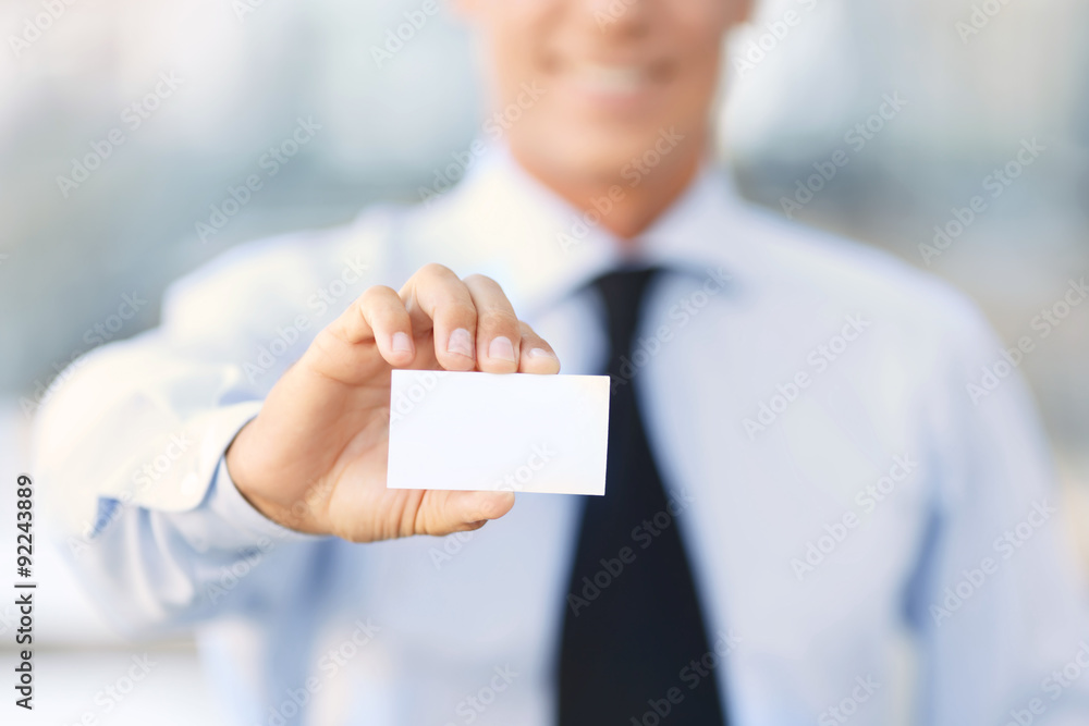 Nice businessman standing near office building Nice businessman standing near office building