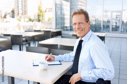 Handsome businessman sitting at the table 