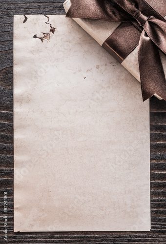 Packed present box paper on vintage wooden board vertical versio photo