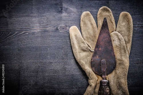 horizontal view vintage tools putty spattle on glove photo