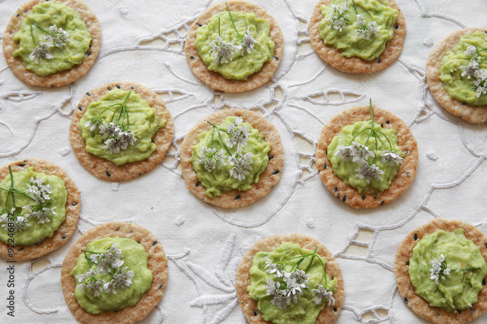 Green avocado crackers with coriander flowers Green avocado crackers with coriander flowers
