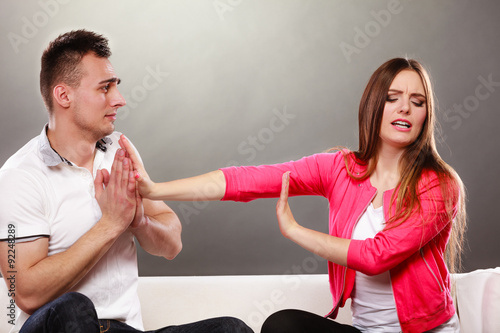 Husband apologizing wife. Angry upset woman. photo