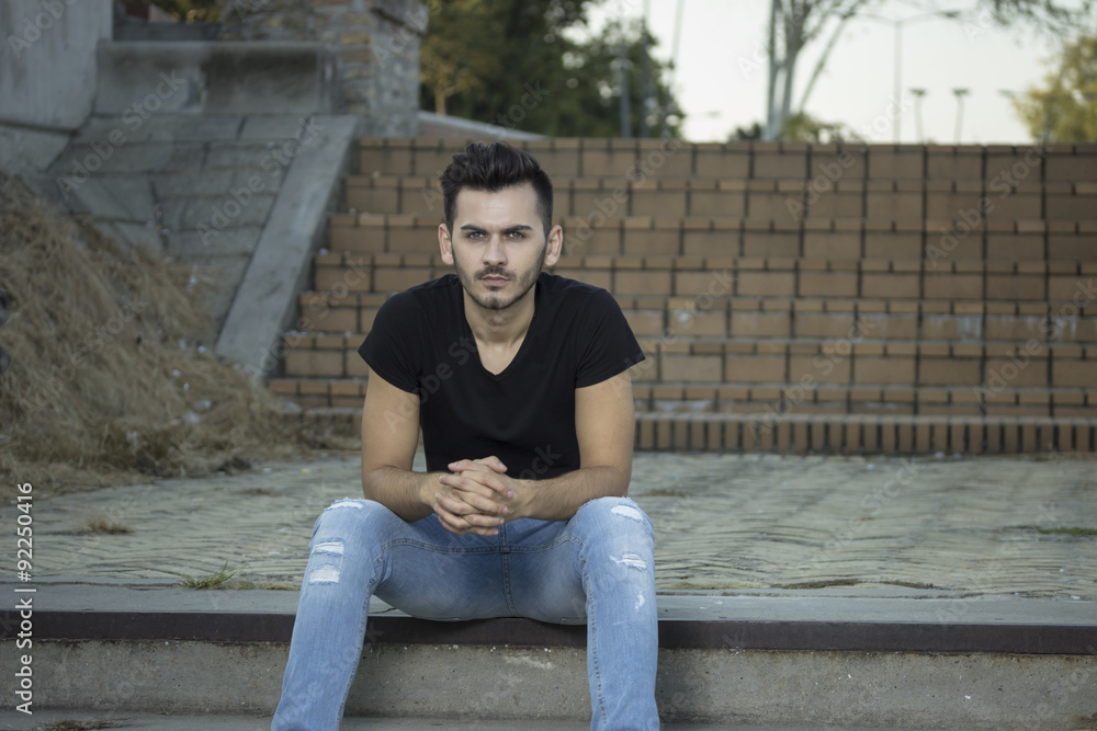 young men posing, sitting on old stairs. young men posing, sitting on old stairs.