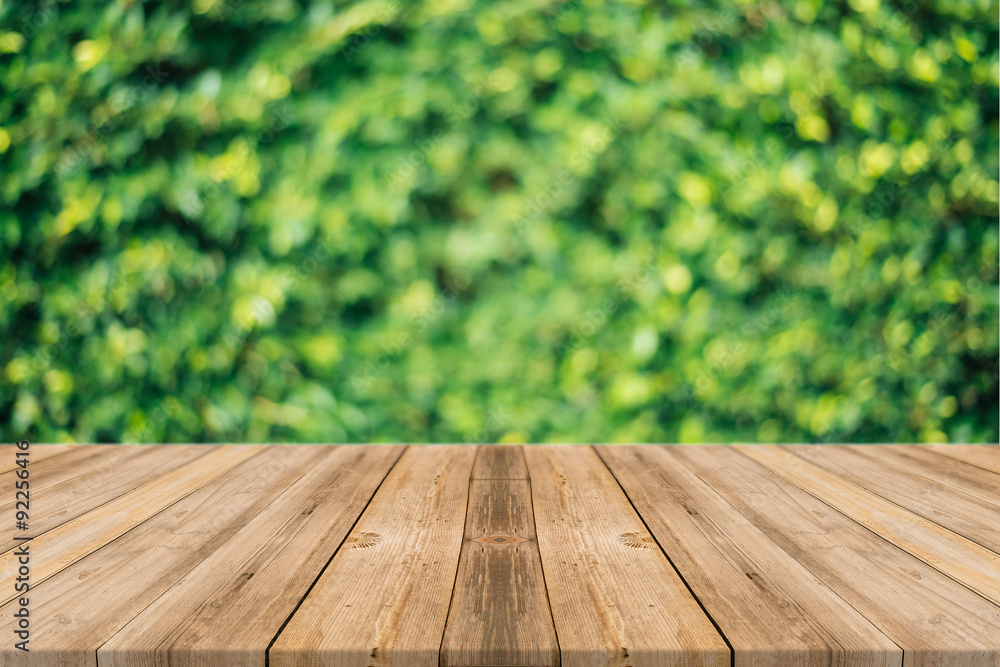 Wooden board empty table in front of blurred background. Perspective brown wood over blur trees in forest - can be used for display or montage your products. spring season. vintage filtered image. Wooden board empty table in front of blurred background. Perspective brown wood over blur trees in forest - can be used for display or montage your products. spring season. vintage filtered image.