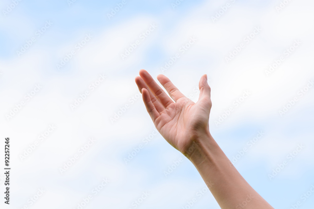 Young woman hand on sky