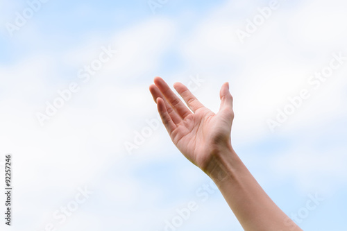 Young woman hand on sky