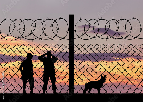 Billede på lærred Silhouette of the military with a dog