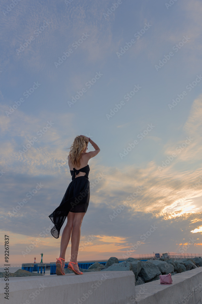 Beautiful woman standing blue sky sunset background Beautiful woman standing blue sky sunset background