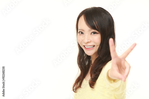 Wallpaper Mural young Japanese woman showing a victory sign Torontodigital.ca
