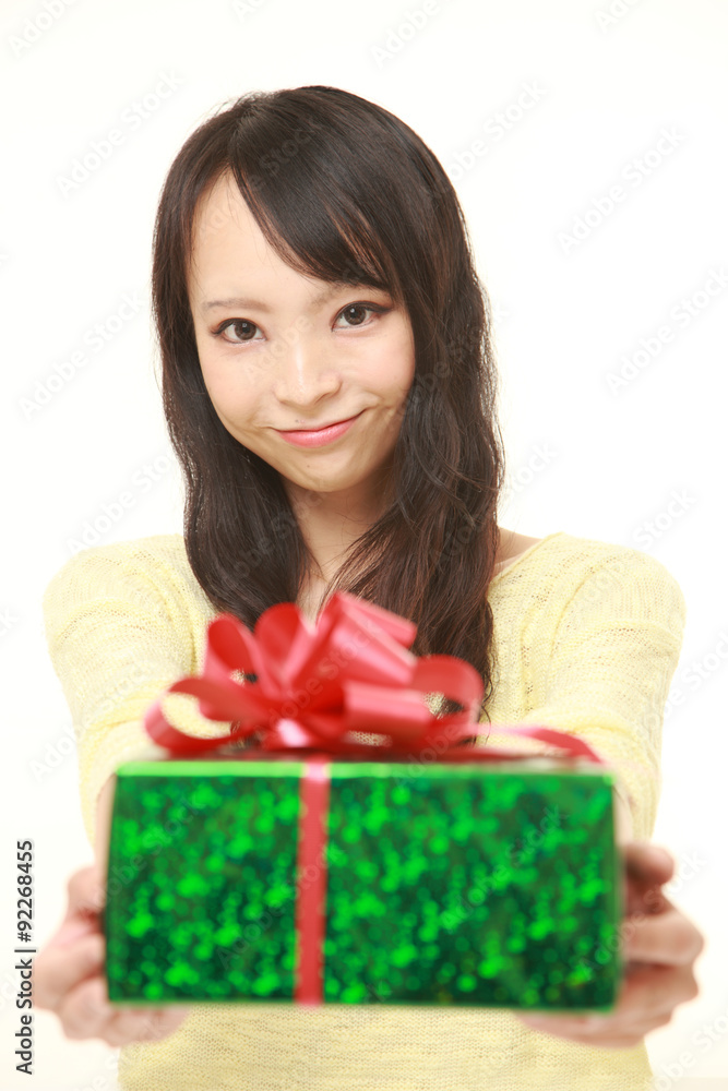 young Japanese woman offering a gift young Japanese woman offering a gift
