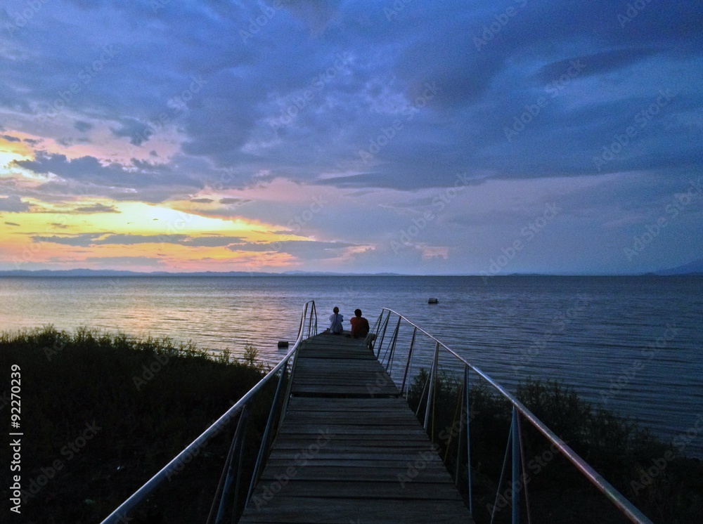 Couple watching a sunset, Moyogalpa Pier, Ometepe Island, Nicaragua