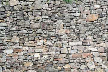 Fototapete Steine Textur der alten verwitterten mittelalterlichen Steinmauer  © Ezio Gutzemberg