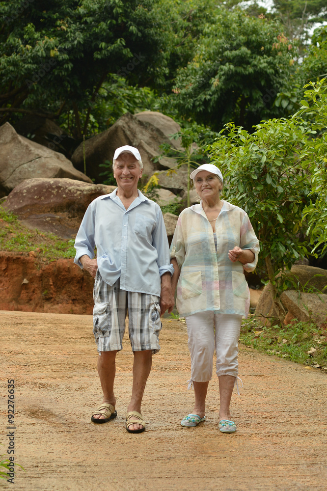 Happy elderly couple walking on air Happy elderly couple walking on air