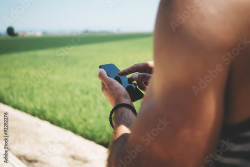 Fototapeta Naklejka Na Ścianę i Meble -  Mock up of hipster man looking in his smartphone 