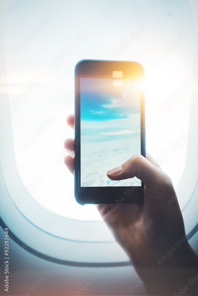 Mock up of girl handing smartphone in hands, private jet Mock up of girl handing smartphone in hands, private jet