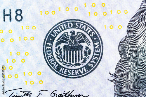 Federal reserve system symbol on hundred dollar bill closeup mac