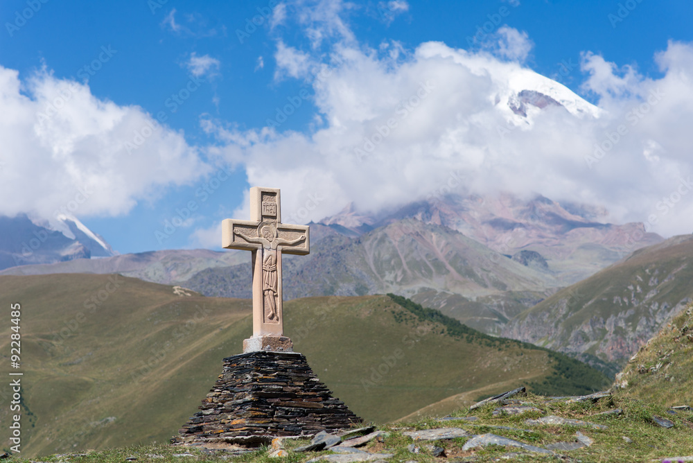 View of Kazbeg mountain and a cross, by the trinity church, Georgia