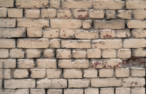Texture of old crumbling brick walls, painted gray