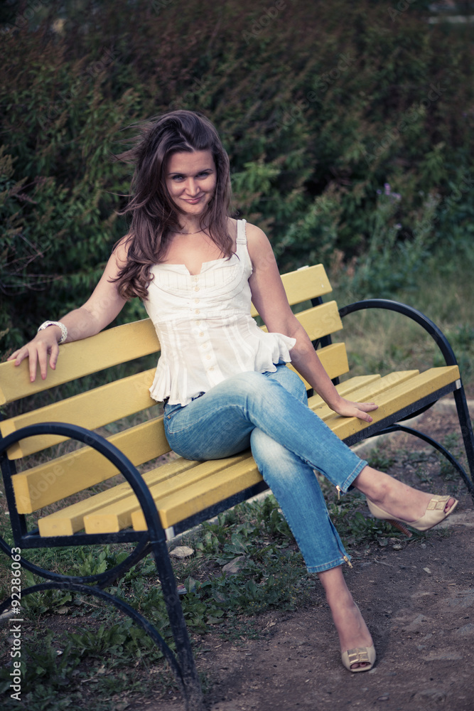 beautiful woman sit on a bench in park beautiful woman sit on a bench in park