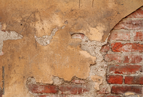 Texture of old wall covered with yellow stucco