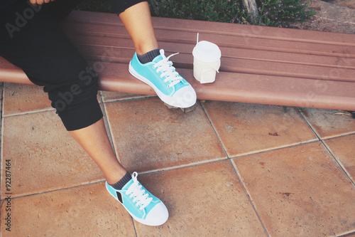 Coffee paper cup with sneakers