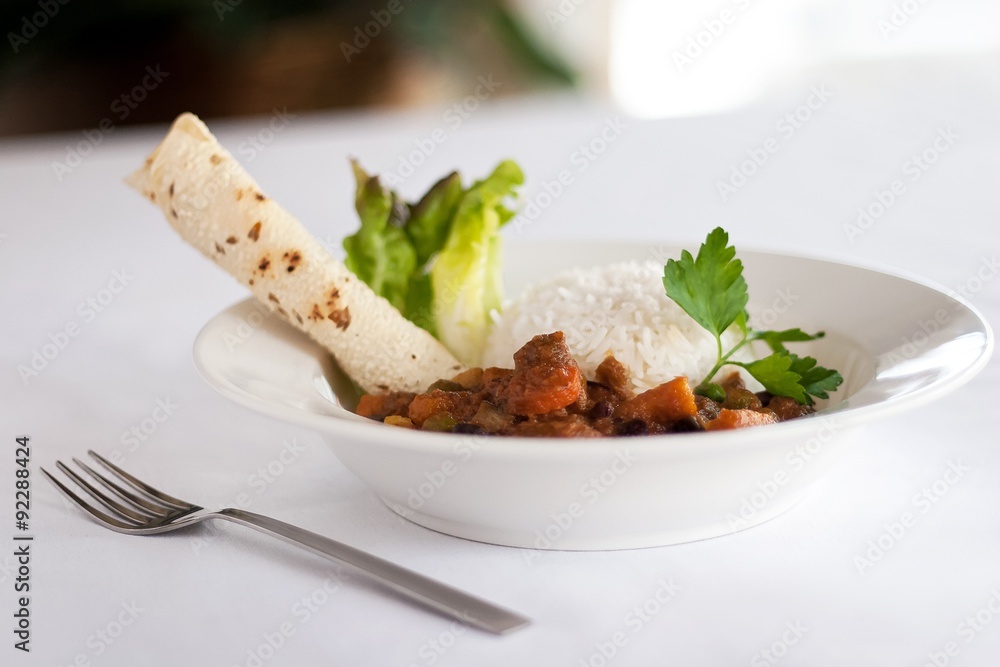 Bowl of Indian vegetable curry with rice and naan Bowl of Indian vegetable curry with rice and naan