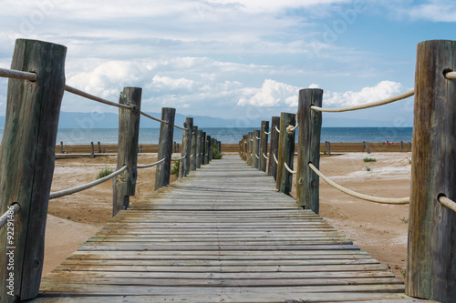 Wooden bridge on sandy beach of the Mediterranean see