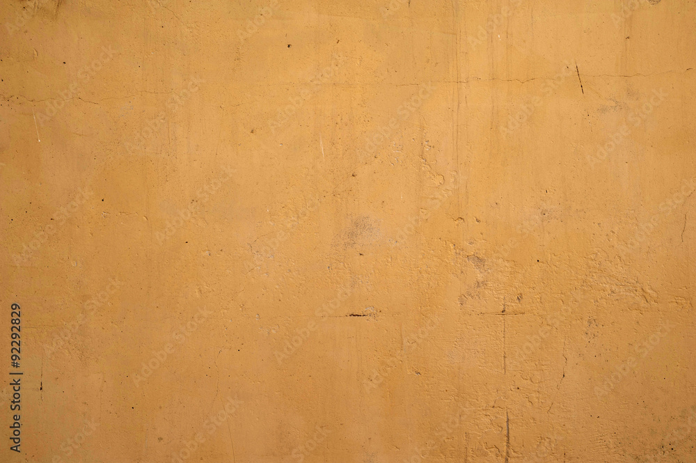 Texture of old wall covered with yellow stucco Texture of old wall covered with yellow stucco