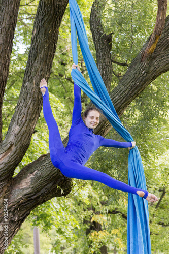 Girl training on silks on open air