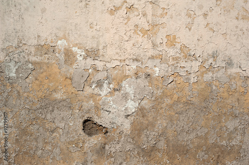 Texture of old wall covered with yellow stucco