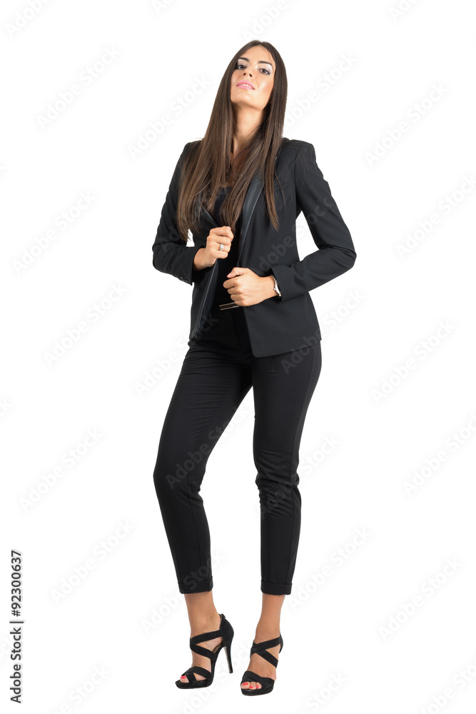 Seductive elegant beauty in black suit holding collar with head leaned back Seductive elegant beauty in black suit holding collar with head leaned back